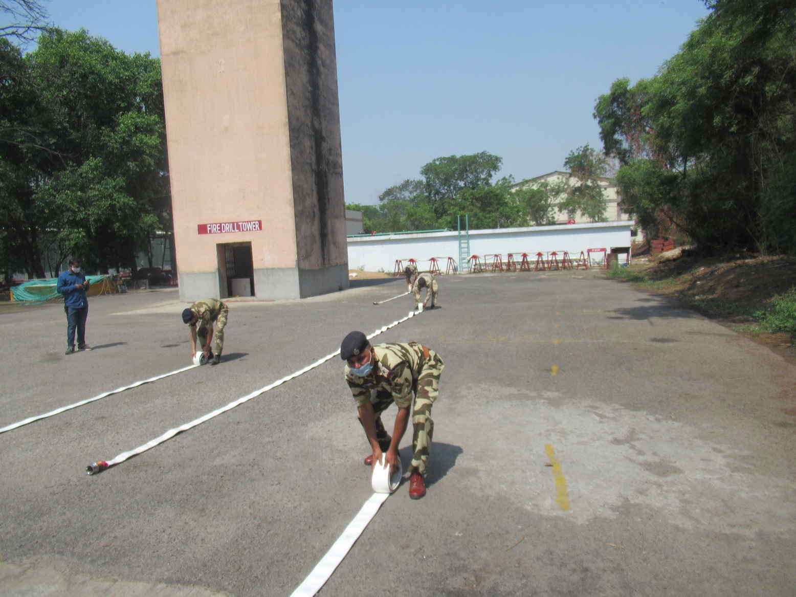 Personnel of Central Industrial Security Force participating in hose laying drill competition during National Fire Service Week.