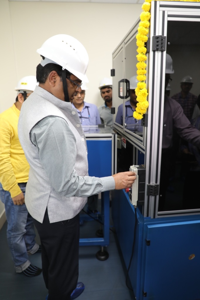 Chairman & Chief Executive, NFC initiating the operation of the facility.