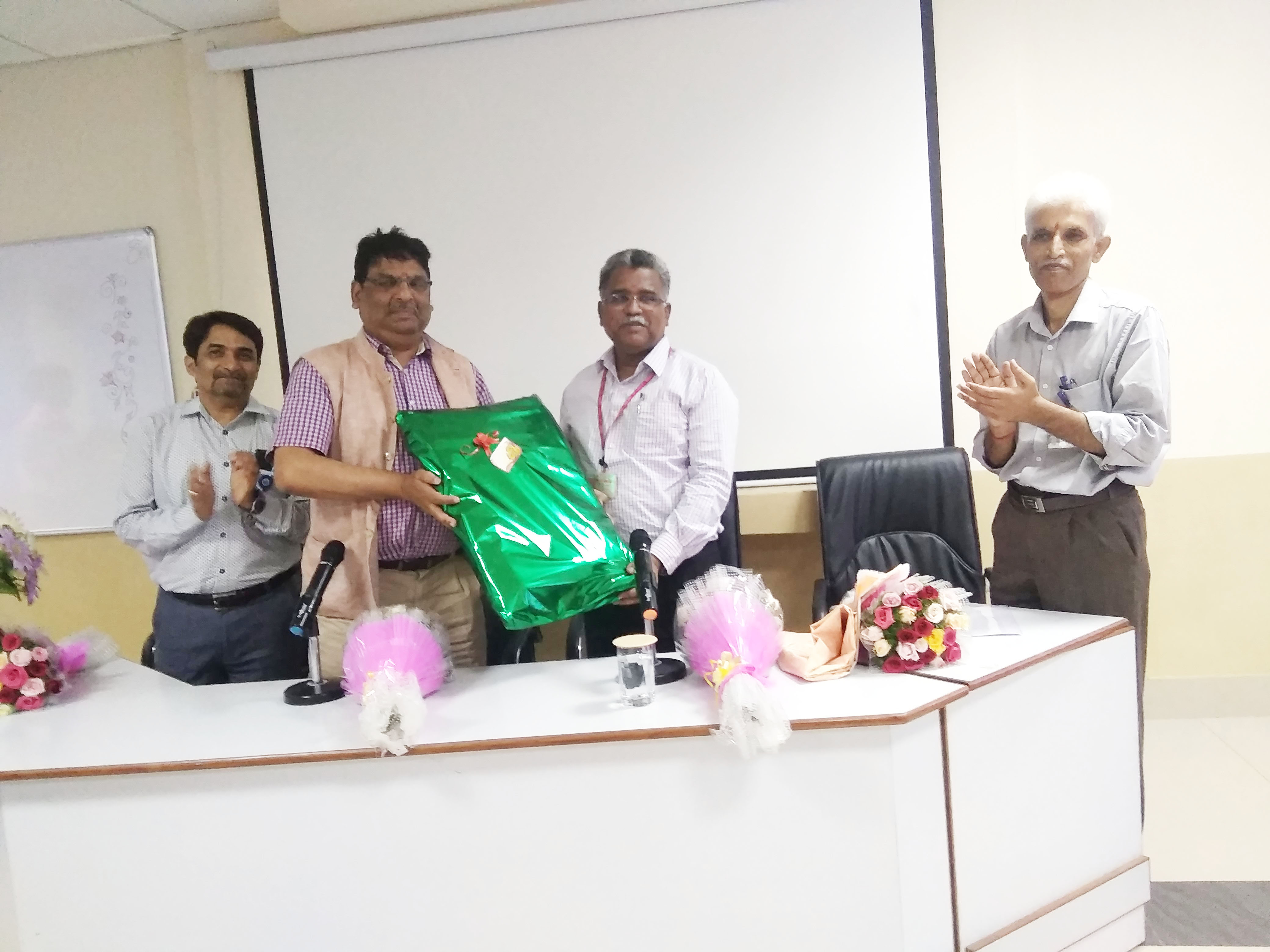 A memento being presented to Shri Puthiyavinayagam